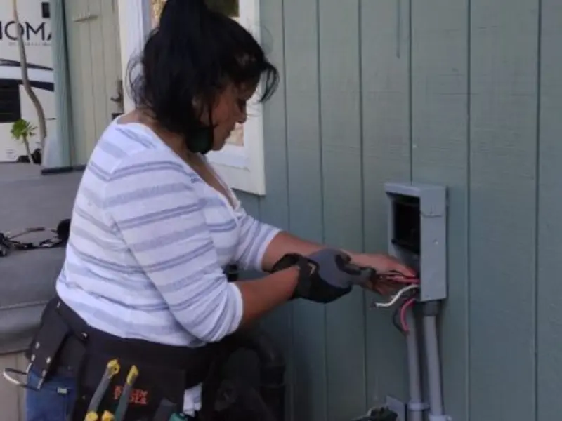 Licensed electrician wiring an exterior subpanel in El Cajon
